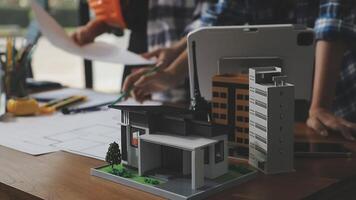 A man and woman working on a model of a house video