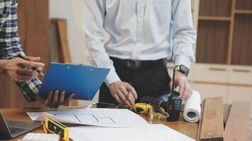 Two men working on a project at a table video