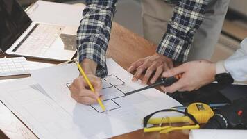 Two people working on a project with blueprints video