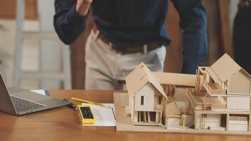 A man is working on a model of a house video