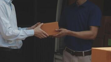 Two men are handing a box to another man video