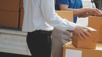 Two men unloading boxes from a truck video