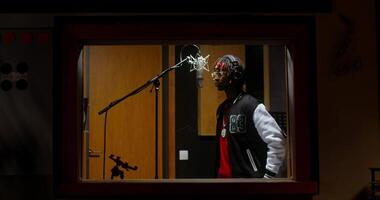 A man in a recording studio with a microphone video
