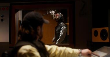 A man in a recording studio with a microphone video