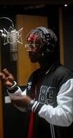 A man with dreadlocks in a recording studio video