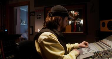 A man in a recording studio with a microphone video
