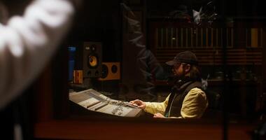 A man in a recording studio with a microphone video
