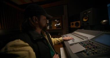 A man in a recording studio with a mixing board video
