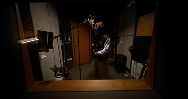 une homme dans une enregistrement studio avec une microphone video