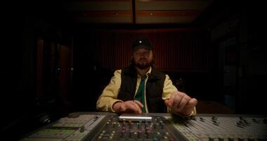 A man in a recording studio with a mixer video