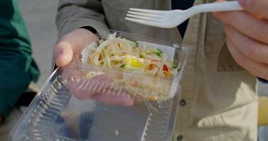 A person holding a plastic container with food in it video