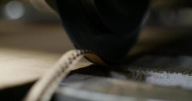 A close up of a machine cutting a piece of wood video