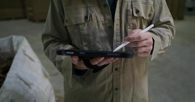 A man holding a pen and a tablet computer video