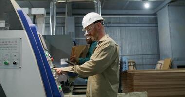 A man in a hard hat working on a machine video