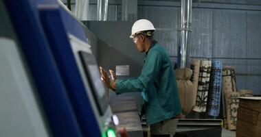 A man in a hard hat working on a machine video
