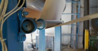 A machine is making paper roll in a factory video
