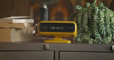 A yellow alarm clock on top of a desk video