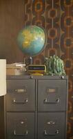 A file cabinet with a globe on top of it video