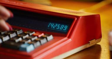 A person is using a calculator on a desk video