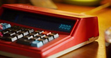A red calculator sitting on a table video