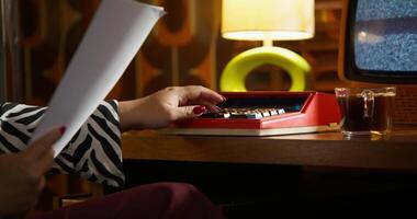 A person sitting at a desk with a typewriter video