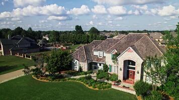 An aerial view of a large home with a driveway and lawn video