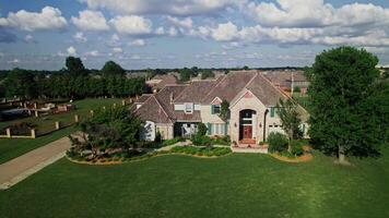 A large home with a large driveway and a large lawn video