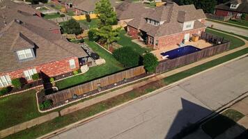 An aerial view of a neighborhood with a pool and a fence video