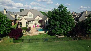 An aerial view of a large home with a pool video