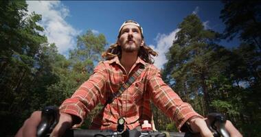 A man riding a bicycle through the woods video
