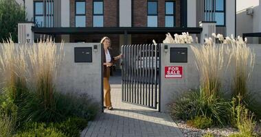 A woman is standing in front of a gate video