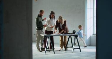 A family of four standing in an unfinished room video