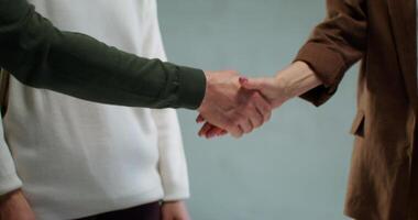 Two people shaking hands in front of each other video