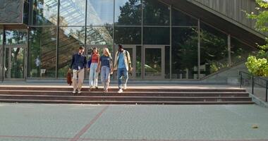Three people walking down steps in front of a building video