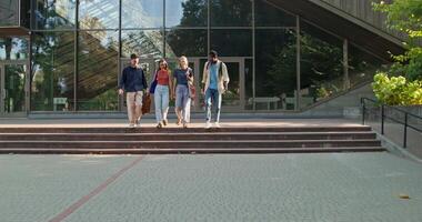 Three people walking on steps outside of a building video