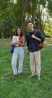 Two people standing in a field with a book video