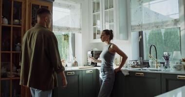 A man and woman standing in a kitchen video