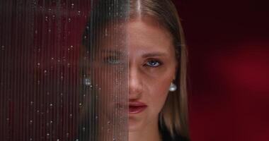A woman is looking through a glass wall video