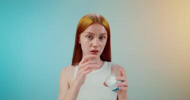 A woman holding a cream in her hand video