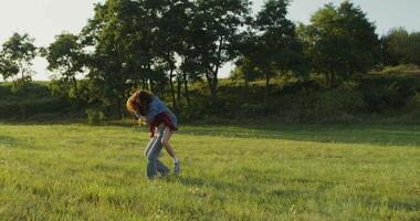 A man carrying a woman in the grass video