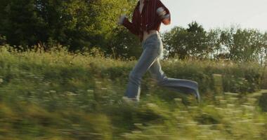 A woman running through a field of grass video
