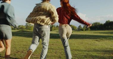 Three people running in a field video