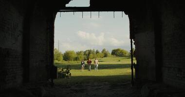 Two people stand in an open doorway looking out into the field video