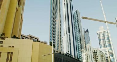 Overview of modern glass skyscrapers in the business center of the city. the moves from the bottom up to the top of the building, sunny day video