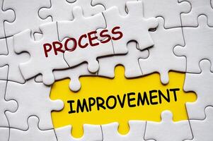 Top view of Process Improvement on jigsaw puzzle. Continuous Process Improvement concept photo