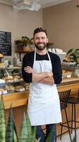 A man standing in front of a bakery counter photo