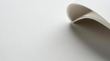 A folded piece of paper on a white surface photo