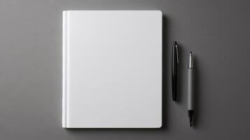 Blank notebook with pen and pen on gray background photo