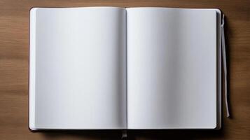 An open white notebook on a wooden table photo