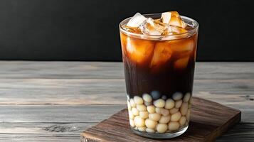 An iced coffee with ice cubes on top photo